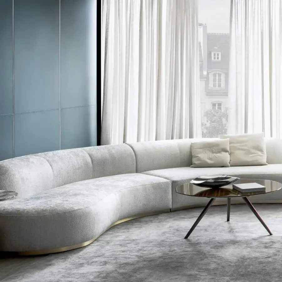 Elegant Rugiano Pierre sectional with curved silhouette upholstered in light textured textile and bronze metal trim
