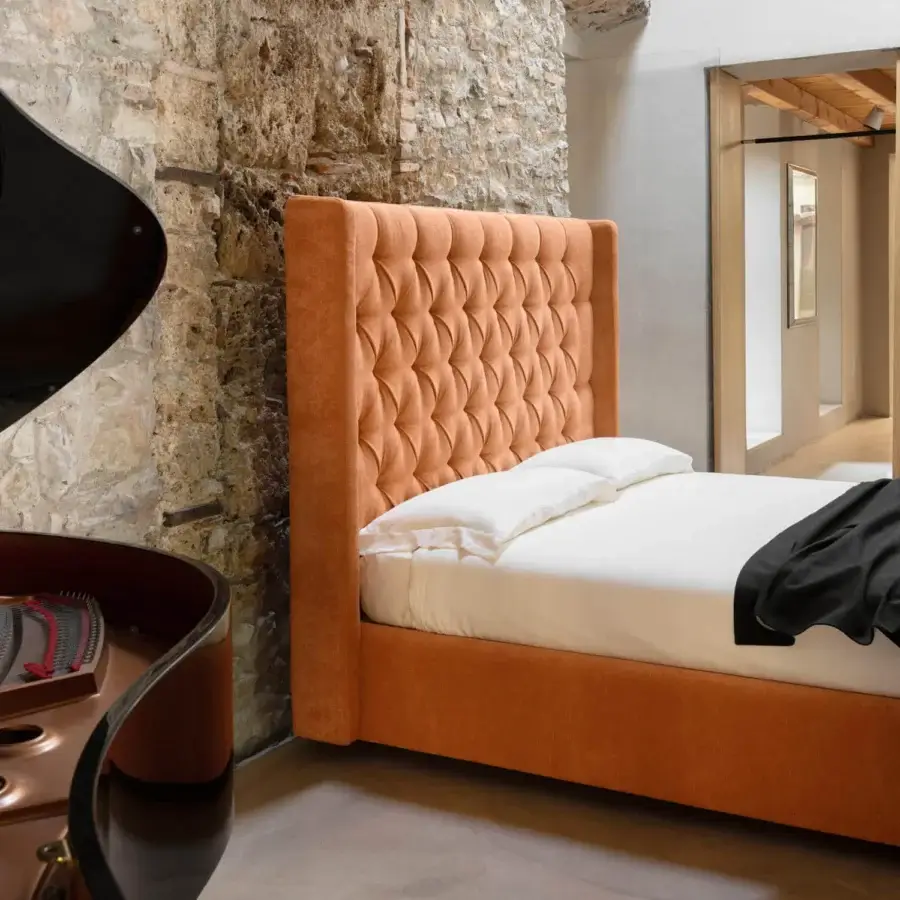 Luxury Noctis Star bed in terracotta textile with tall wingback headboard and deep tufted capitonné Italian craftsmanship