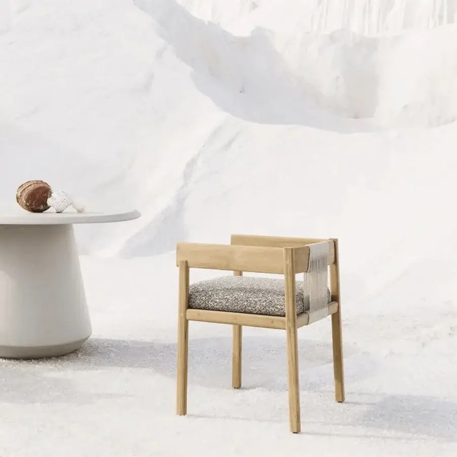 Exquisite Unopiù Cora chair in solid teak with matte light toned finish woven off white rope backrest and grey speckled…