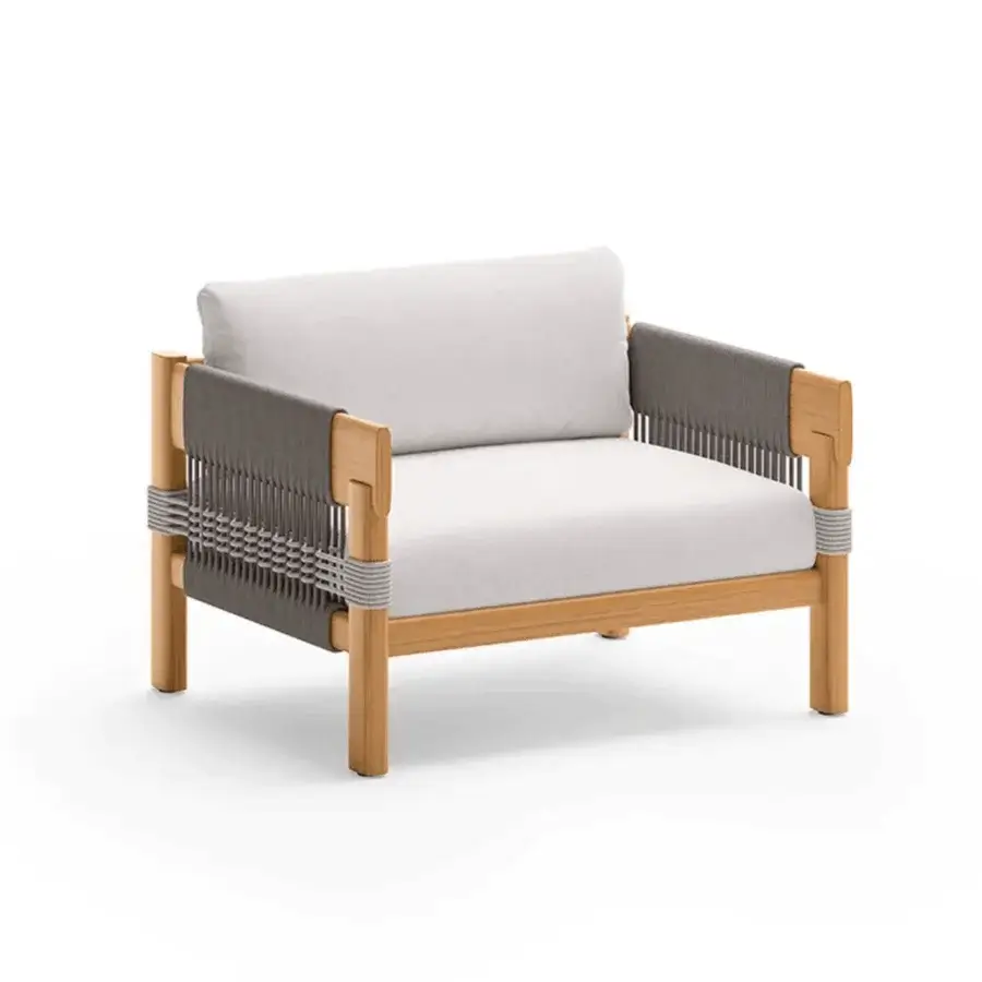 Elegant Unopiù Cora lounge chair featuring solid teak frame woven rope arms and off-white upholstered cushions