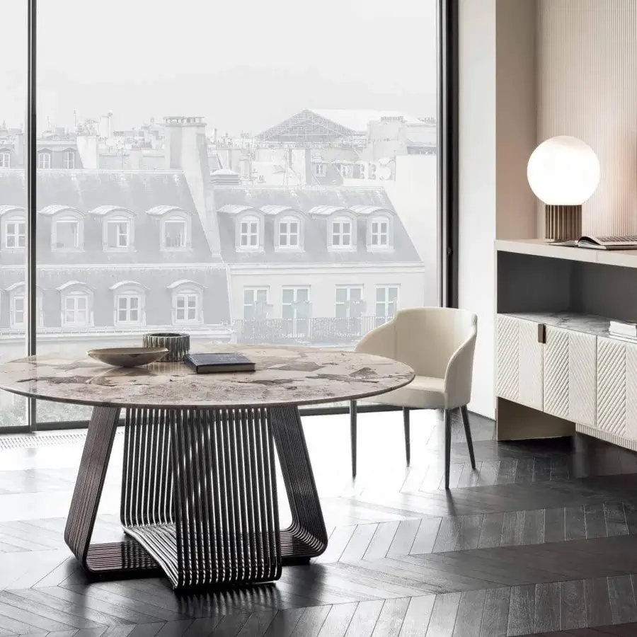 Distinguished Rugiano Alyson round table with curved black chrome metal tubes and marbled composite tabletop