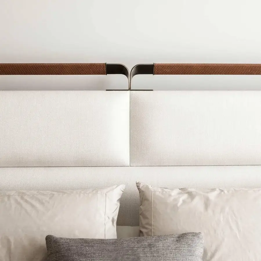 Elegant Rugiano Grace bed with textured off-white upholstery and refined bronze details built with woven brown material