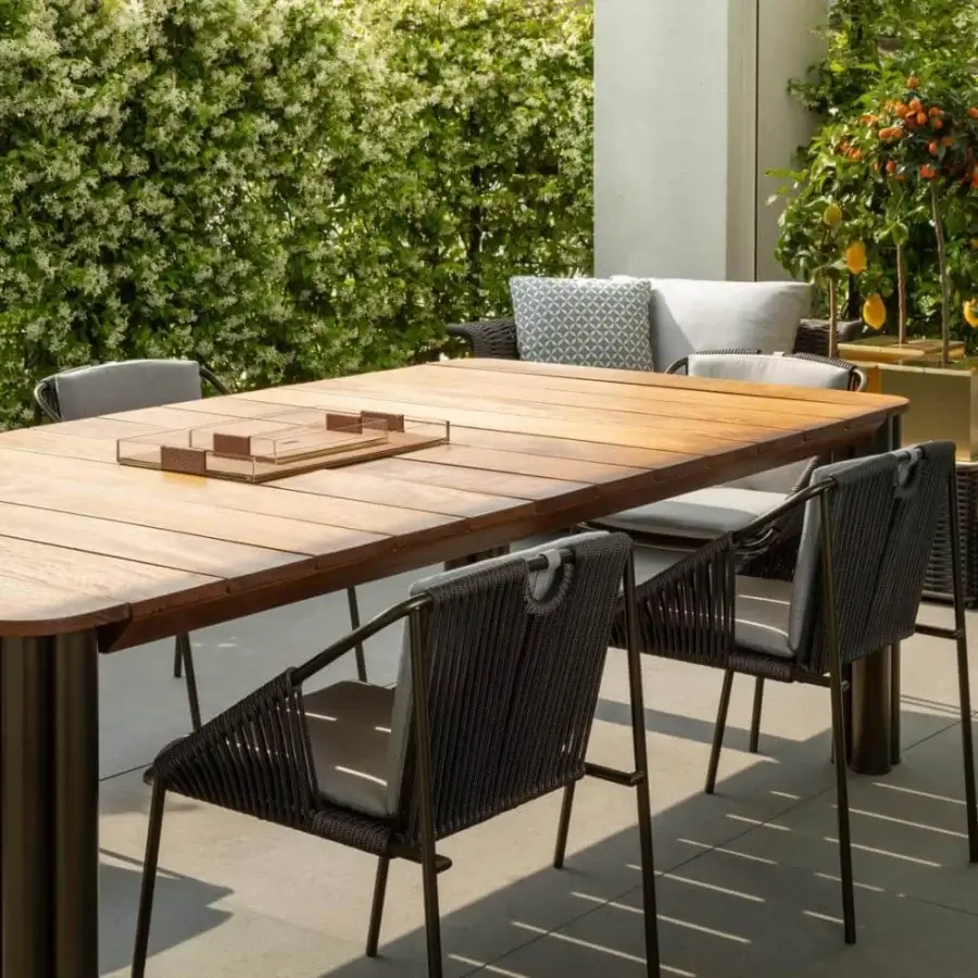 Distinguished Rugiano Atlante table with rectangular Iroko wood showcasing warm brown hues and skillfully welded bronze metal legs
