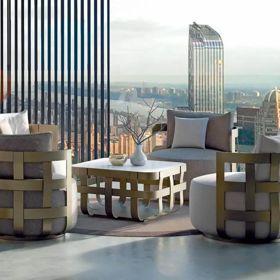 Distinguished Rugiano Dafne lounge chair with woven bronze painted aluminum and comfortable gray fabric cushions