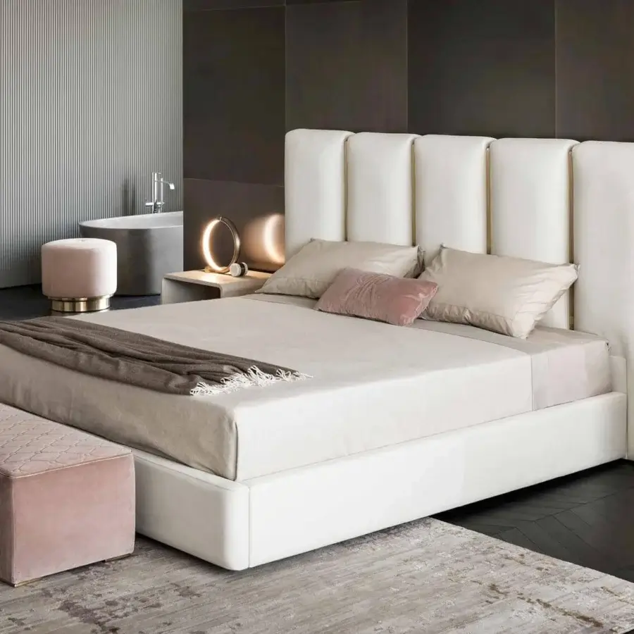Innovative Rugiano Club bed with brushed brass tubes against white upholstered leather or fabric and smooth finish