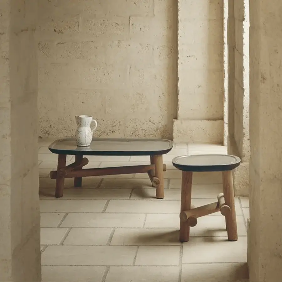 Luxury Unopiù Symi side table featuring smooth neutral tabletop plus warm teak base having cylindrical joinery