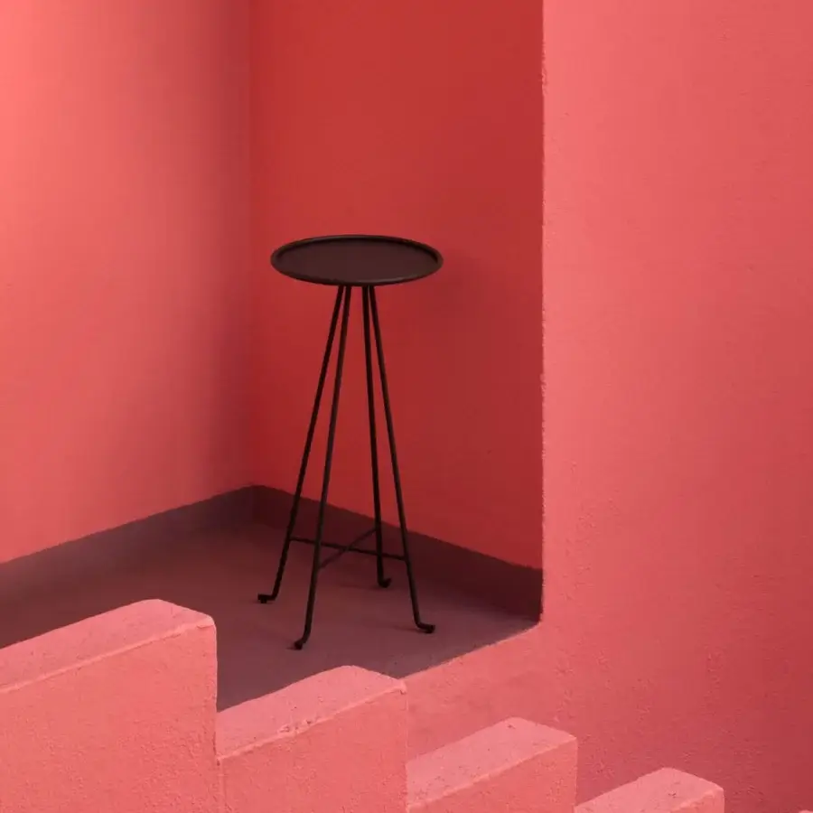Luxury Unopiù Syros side table in matte Graphite powder coated metal with slender circular top and angled braced legs