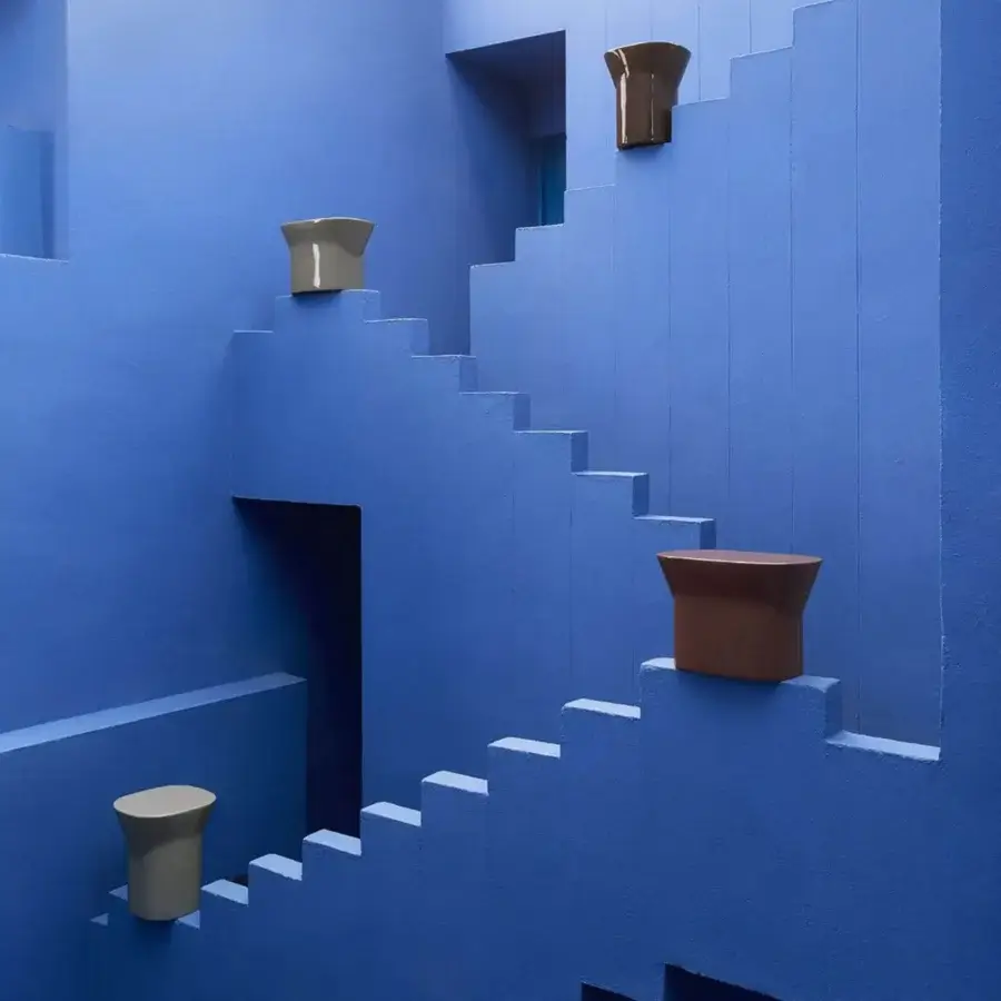 Elegant Unopiù Egadi stool with monolithic flared columnar silhouette crafted from glossy stone synthetic or ceramic