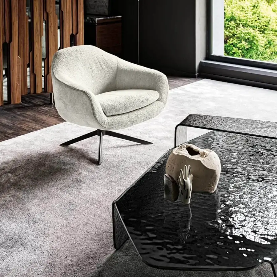 Elegant Arketipo Bond lounge chair with light neutral textile upholstery and dark swivel metal base