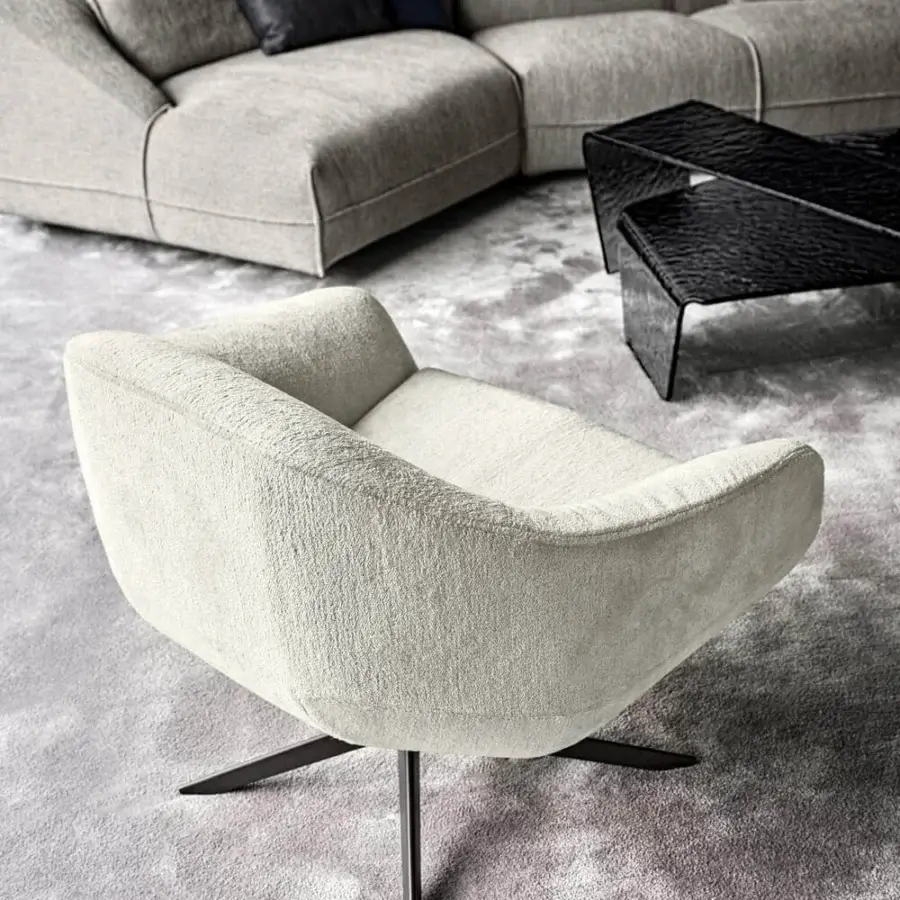 Superior Arketipo Bond lounge chair with textured light gray fabric upholstery and sleek dark metal base