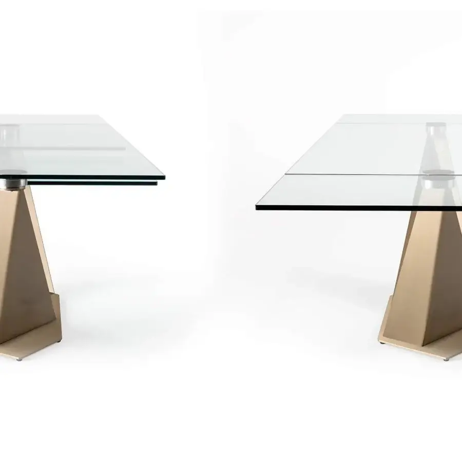 Exclusive Reflex Quartz table with clear tempered glass top and warm light gold metal geometric base in brushed satin finish