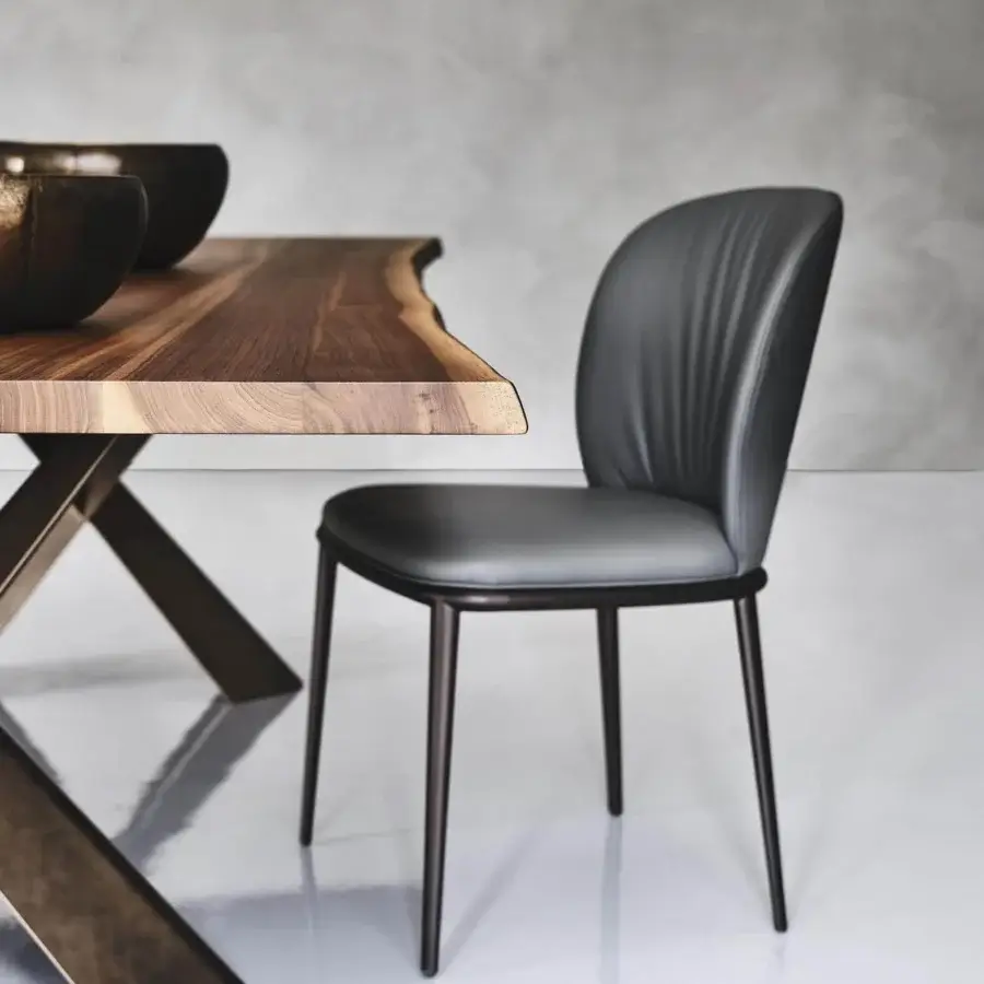 Sophisticated Cattelan Italia Chris chair with curved form in gray synthetic leather and embossed lacquered steel legs