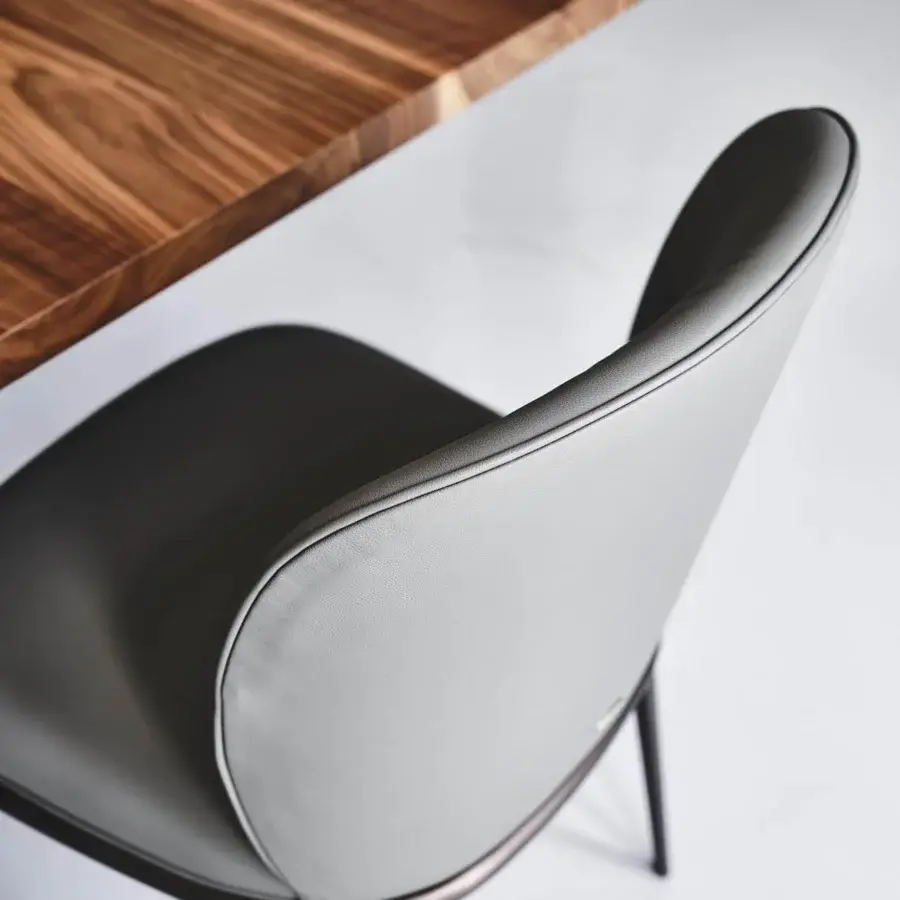 Elegant Cattelan Italia Chris chair with curved silhouette in gray synthetic leather and bronze embossed lacquered steel base