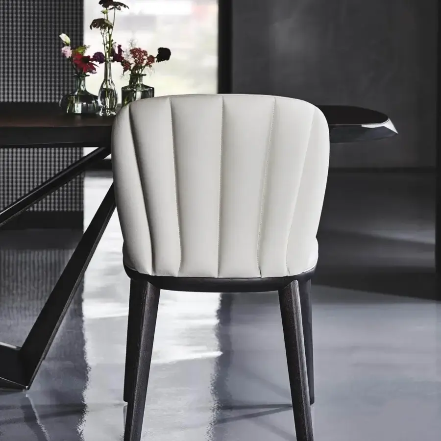 Distinguished Cattelan Italia Chrishell chair with curved silhouette upholstered in white synthetic leather and open pore matt black ashwood base