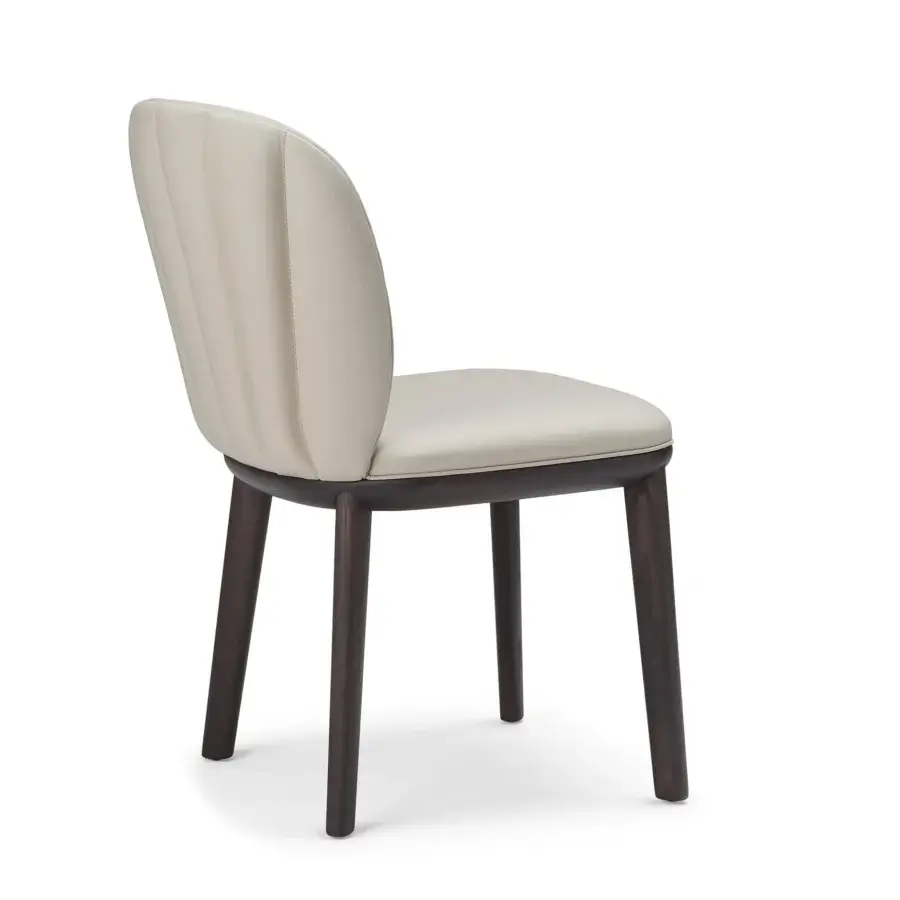 Distinguished Cattelan Italia Chrishell chair with curved form in light beige synthetic leather and Canaletto walnut stained ashwood base