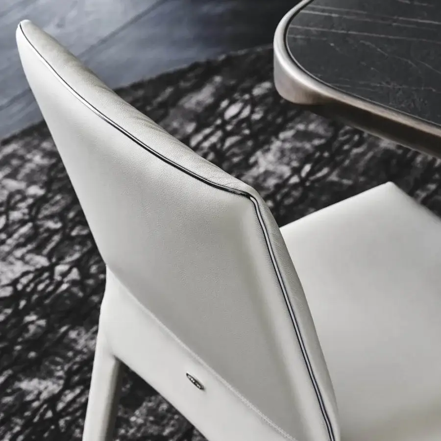 Exceptional Cattelan Italia Penelope chair with light gray synthetic leather and gun metal grey piping detail