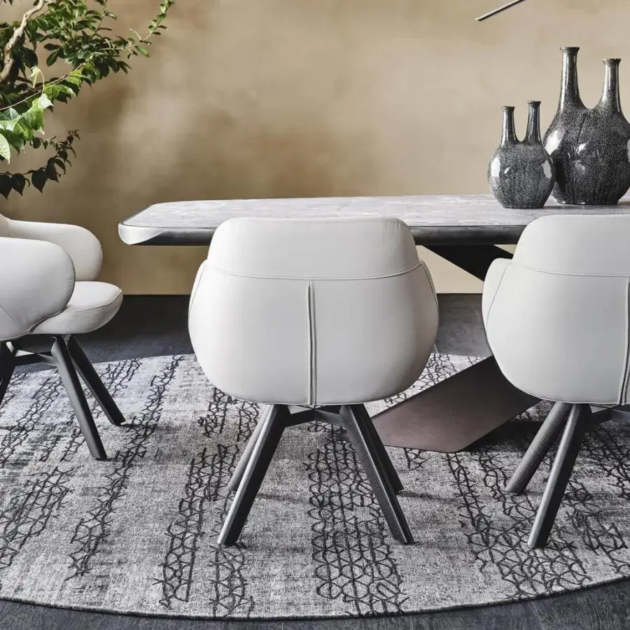 Superior Cattelan Italia Bombè armchair with light grey upholstery and Canaletto walnut stained legs built with a graphite embossed lacquered steel base