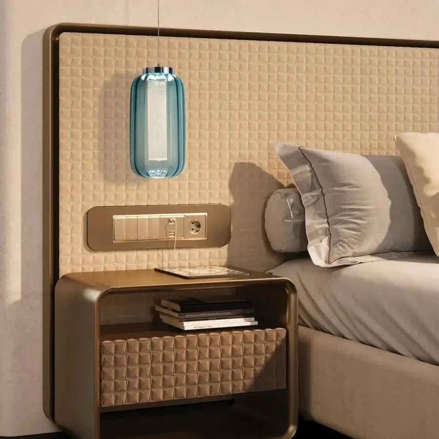 Refined Reflex Oh XL bed with quilted light beige fabric and bronze finished wooden frame with integrated drawer
