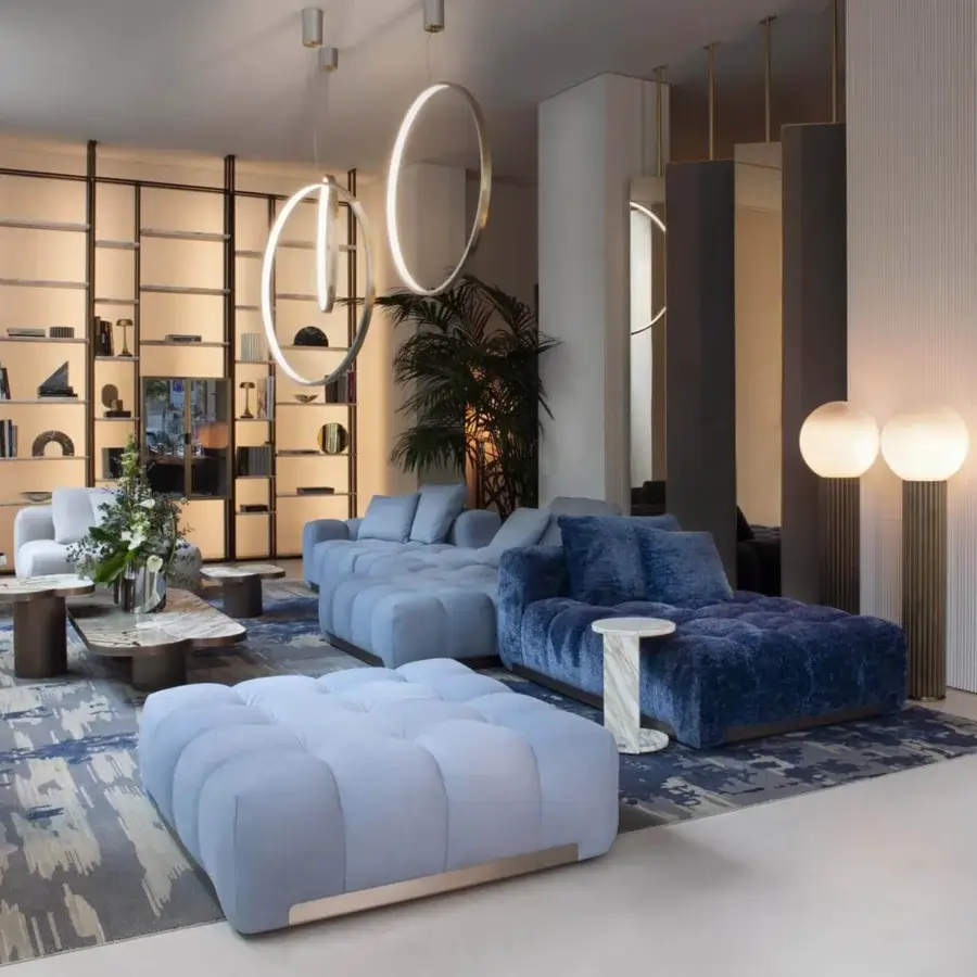 Distinguished Rugiano Yacht sectional with soft lines upholstered in light blue textile and textured blue chaise lounge with bronze brass details