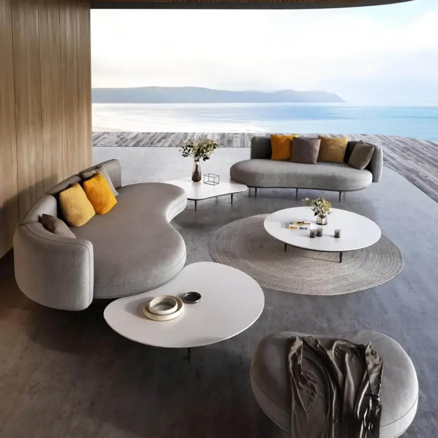 Captivating Royal Botania Organix lounge sofa with kidney-shaped seat, smooth light gray textile and vibrant orange cushions