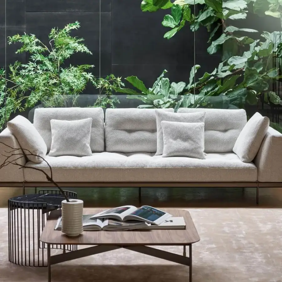 Refined Bonaldo Maximilian sofa with light textile upholstery and textured finish supported by oval tubing in matt varnished metal