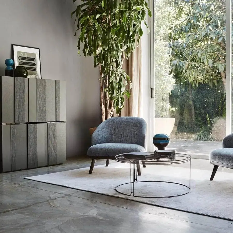 Sophisticated Ditre Italia St Tropez lounge chair with curved backrest upholstered in blue textile and tan accents built on a solid wood base