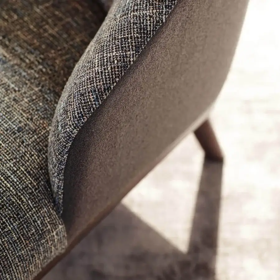 Lavish Ditre Italia St Tropez lounge chair with curved form upholstered in woven browns, grays and blues with dark brown side panels
