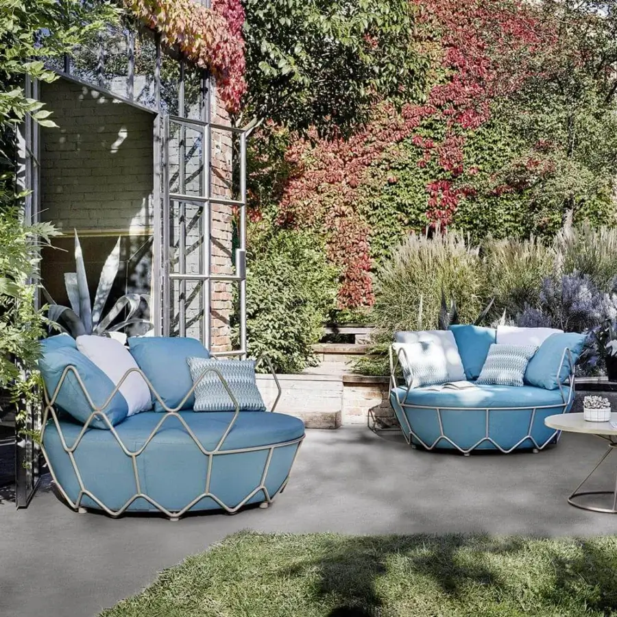 Superior Roberti Rattan Gravity lounge chair with stainless steel frame and light blue textile cushion