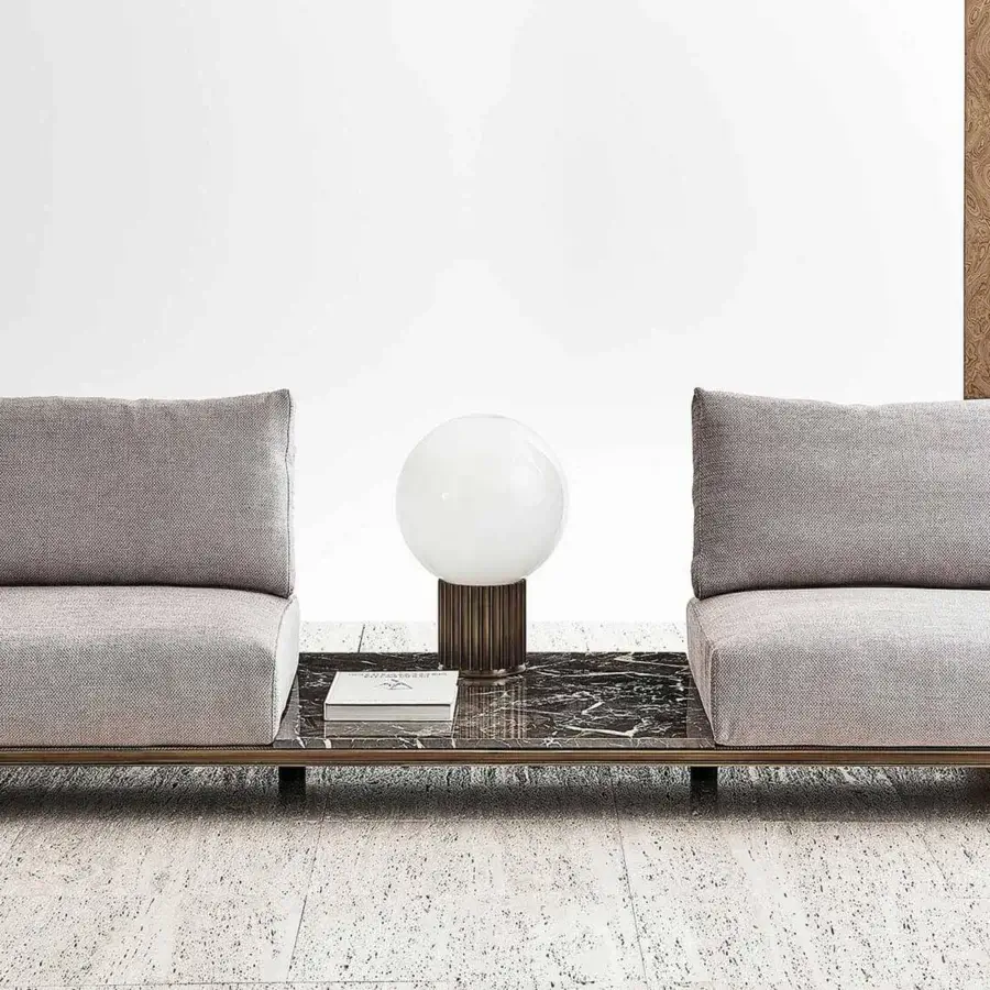 Elegant Rugiano Memphis sofa with woven armrests braided in velvet rope and grey textile cushions with a bronze tone metal base and dark marble table