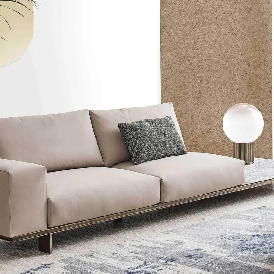 Distinguished Rugiano Memphis sofa with light beige textile upholstery and refined marble side table built with a sleek metal base