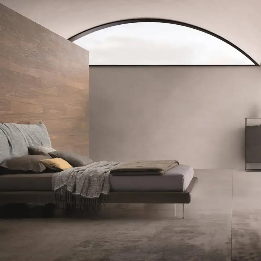 Superior Ditre Italia Papilo bed with plush light gray textile and transparent legs, adorned with brown and gold pillows
