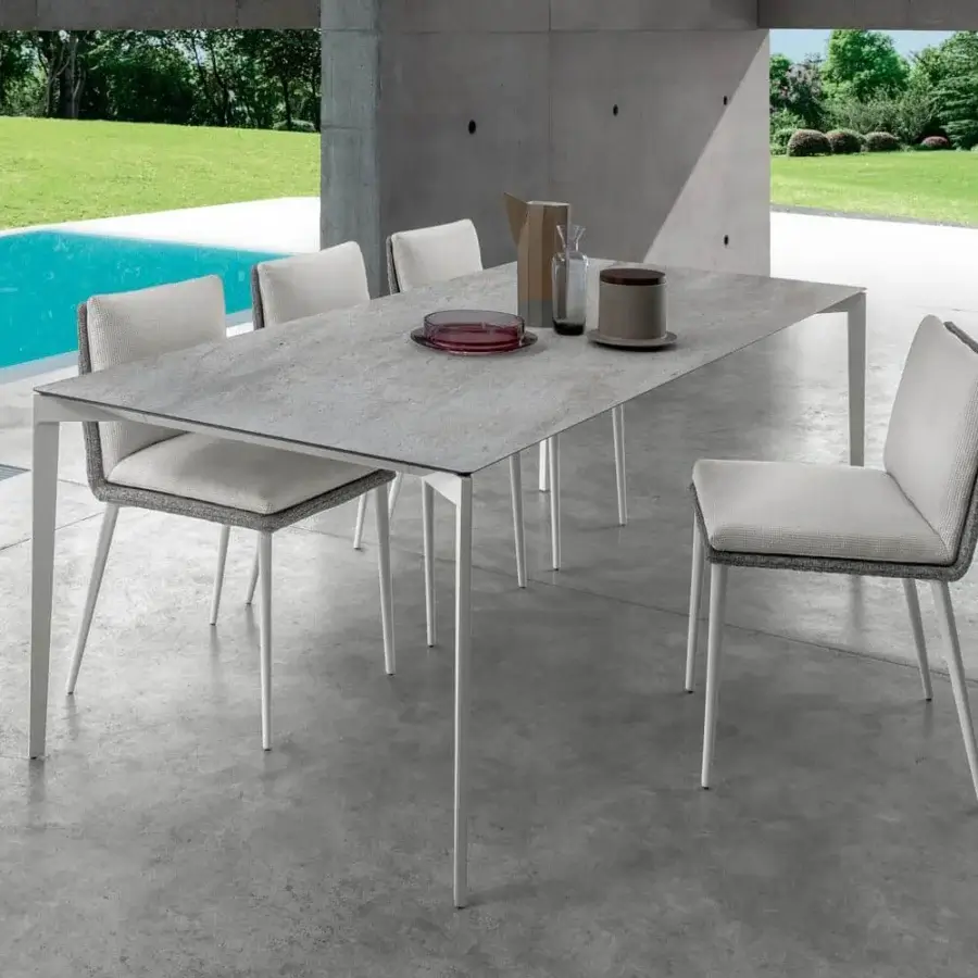 Sophisticated Talenti Leaf chair with light grey aluminum frame and light-colored weatherproof fabric upholstery