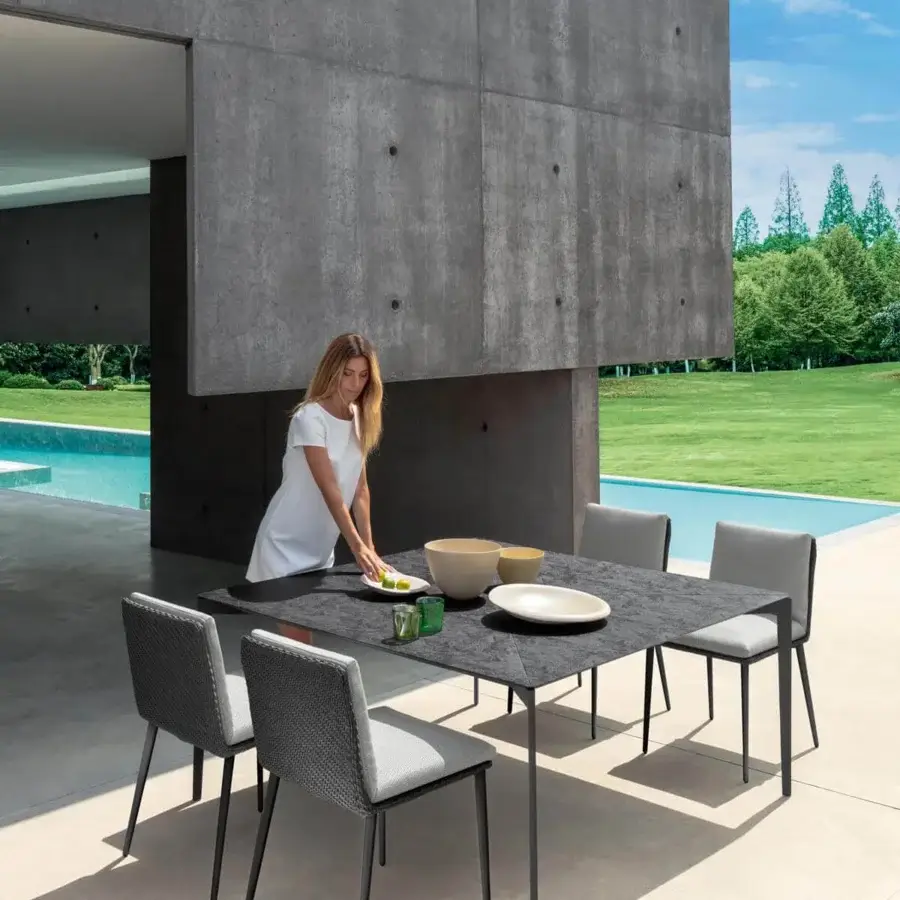 Distinguished Talenti Leaf chair with dark metal frame and textured dark gray weatherproof fabric with a light gray cushioned seat