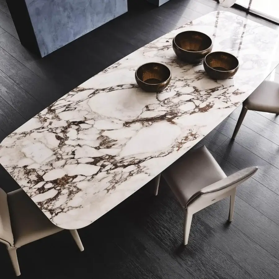 Distinguished Cattelan Italia Tyron table with glossy Golden Calacatta marmi ceramic and graphite embossed lacquered steel base