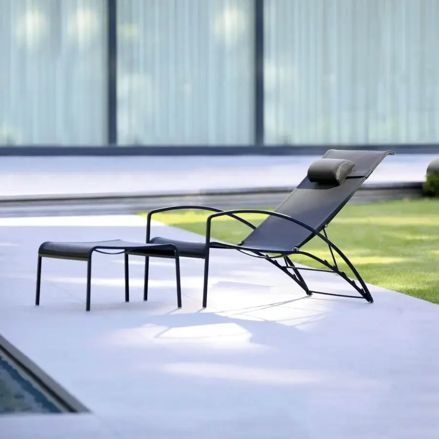 Elegant Royal Botania QT lounger with a curved black metal frame and durable Batyline seat in a matte finish