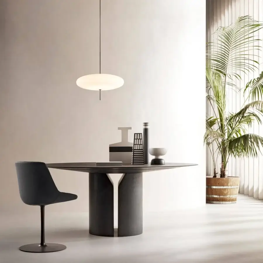 Superior MDF Italia NVL table with a round top and cylindrical legs in black slate reconstructed stone with a textural matte finish