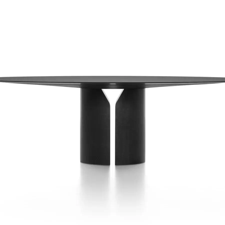 Sophisticated MDF Italia NVL table with rounded top and cylindrical base in matt black medium density fibreboard construction