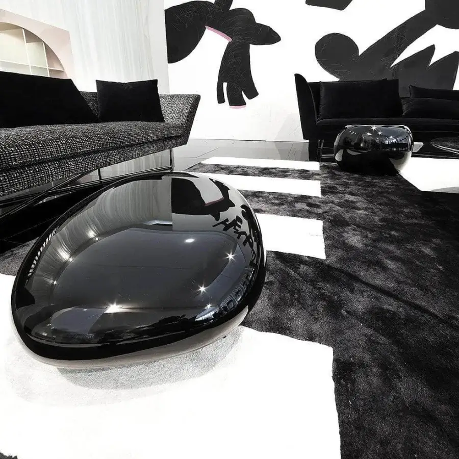 Distinguished Erba Invece ottoman crafted with polymeric material exhibiting a glossy black finish and curvilinear silhouette