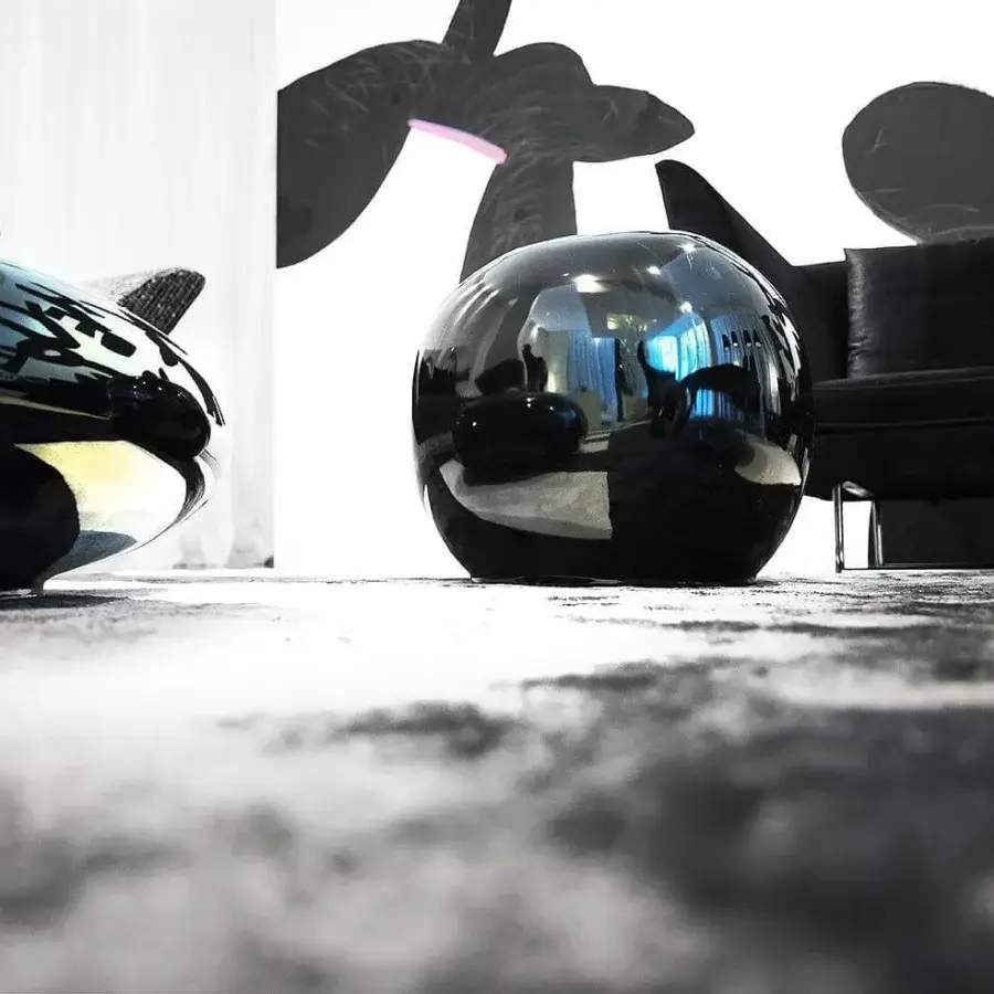 Elegant Erba Invece ottoman with spherical form crafted from patented polymeric material exhibiting a glossy black finish
