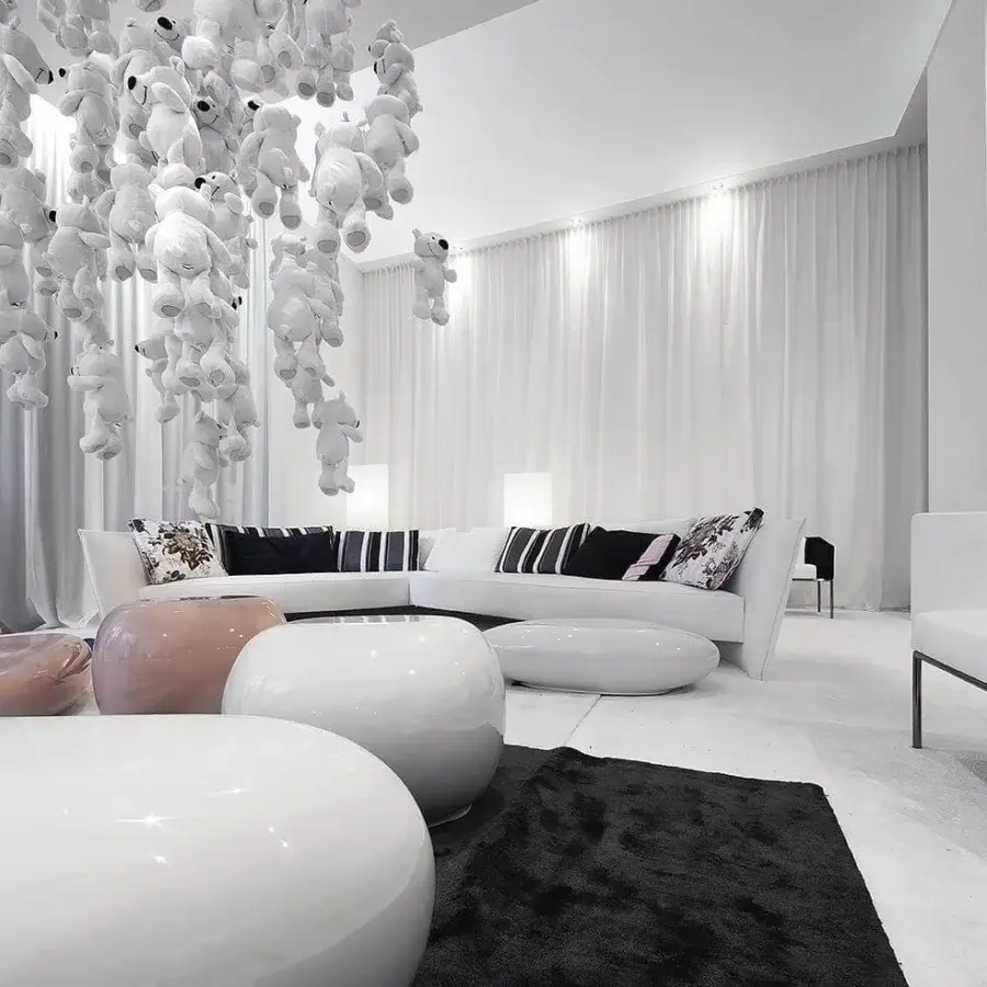 Innovative Erba Invece ottoman with pebble-like shape crafted from polymeric materials and glossy white finish