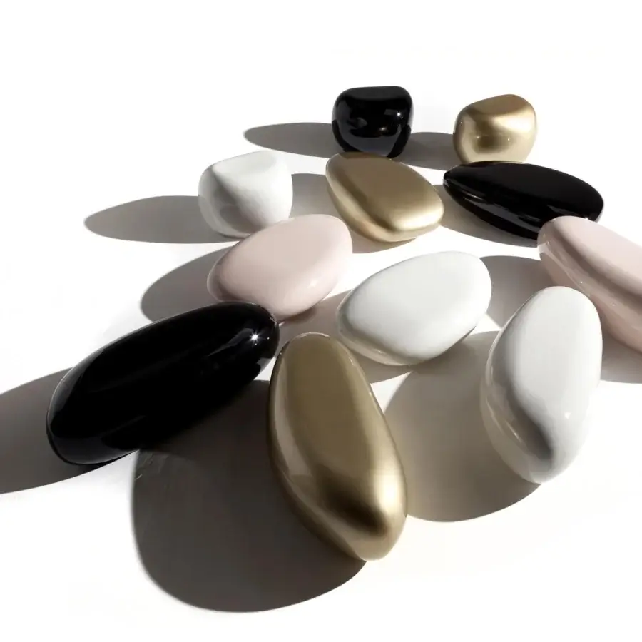 Innovative Erba Invece coffee table in pale pink polymeric materials with a glossy pebble-like form