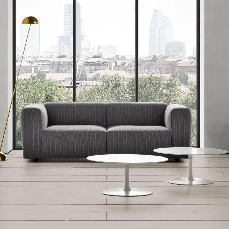 Elegant MDF Italia Flow coffee table with circular matt white Cristalplant® top and painted aluminum pedestal base