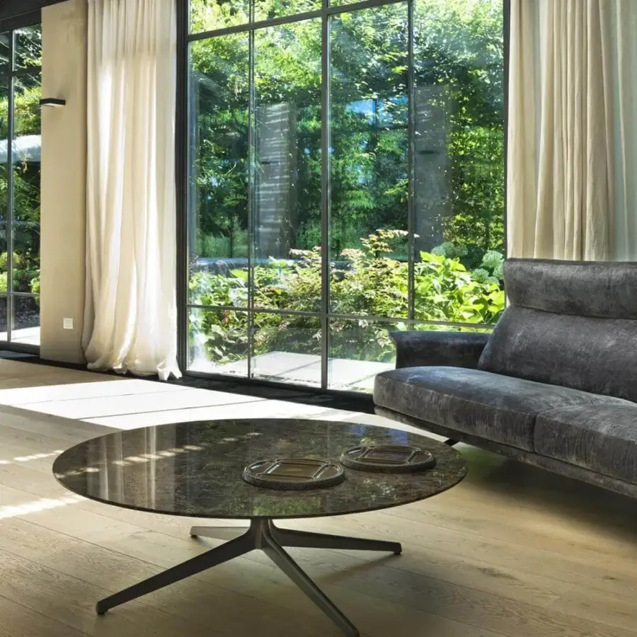 Elegant Verzelloni Antero coffee table with round Black Marquina marble top and bronze lacquered aluminum base