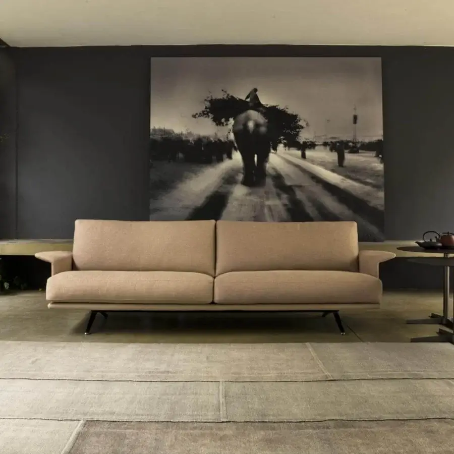 Innovative Verzelloni Nilson sofa with angled armrests upholstered in light beige textile featuring a matte finish