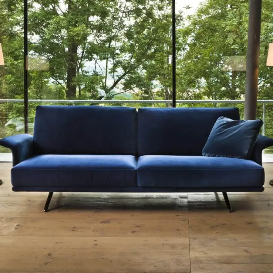 Superior Verzelloni Nilson sofa with curved armrests upholstered in deep blue smooth textile and dark metal legs