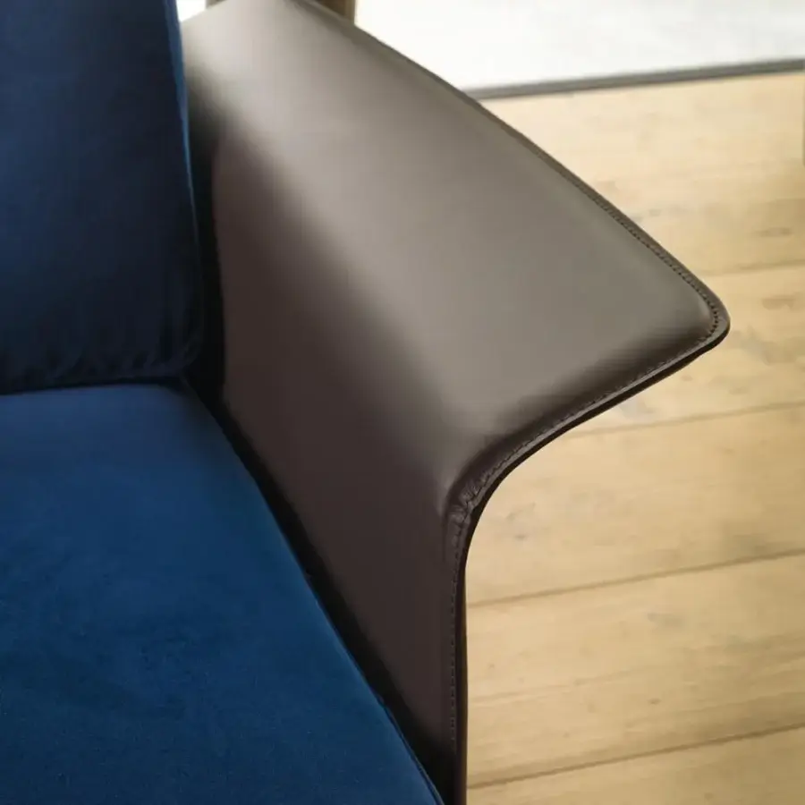Distinguished Verzelloni Nilson sofa with clean lines upholstered in deep blue fabric and dark brown hide leather armrest