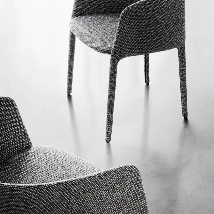 Lavish MDF Italia Achille armchair fully upholstered in textured woven gray textile with continuous curved form crafted from metal tubing