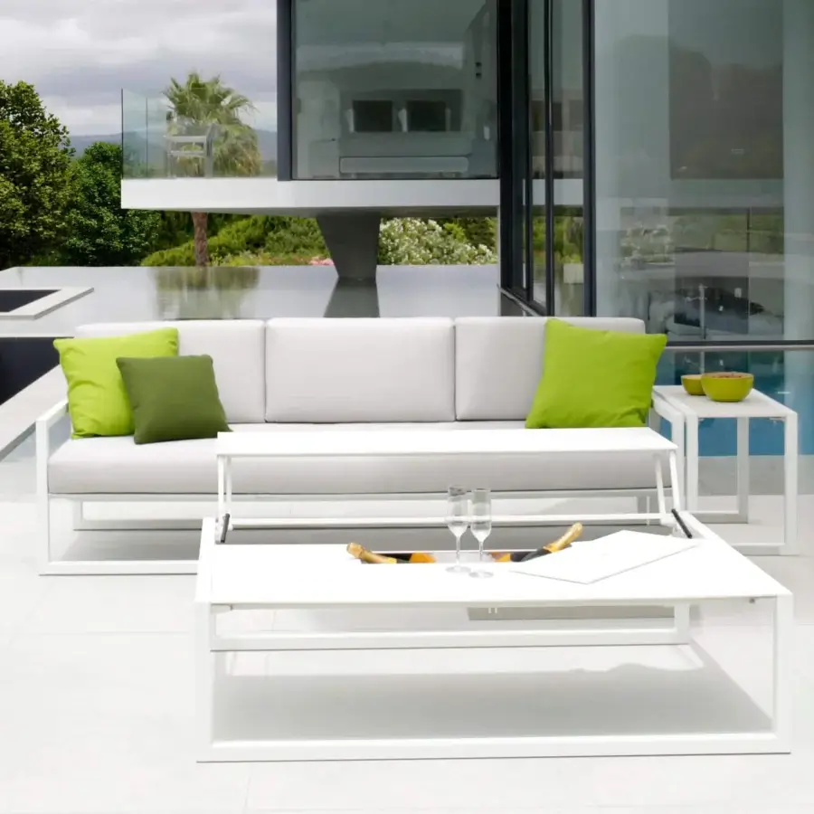 Elegant Royal Botania Ninix lounge sofa with stainless steel frame and light grey Batyline seat complemented by vibrant green fabric cushions