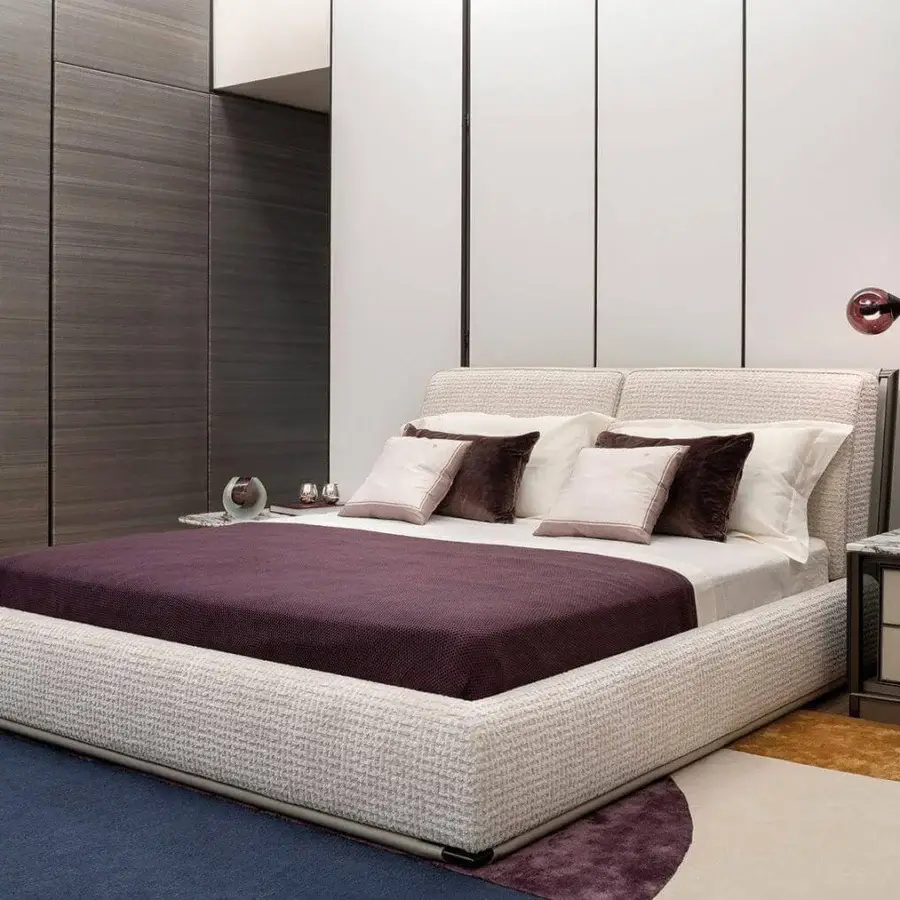Superior Giorgetti Adam bed with light beige woven textile upholstery and coordinating piping detail