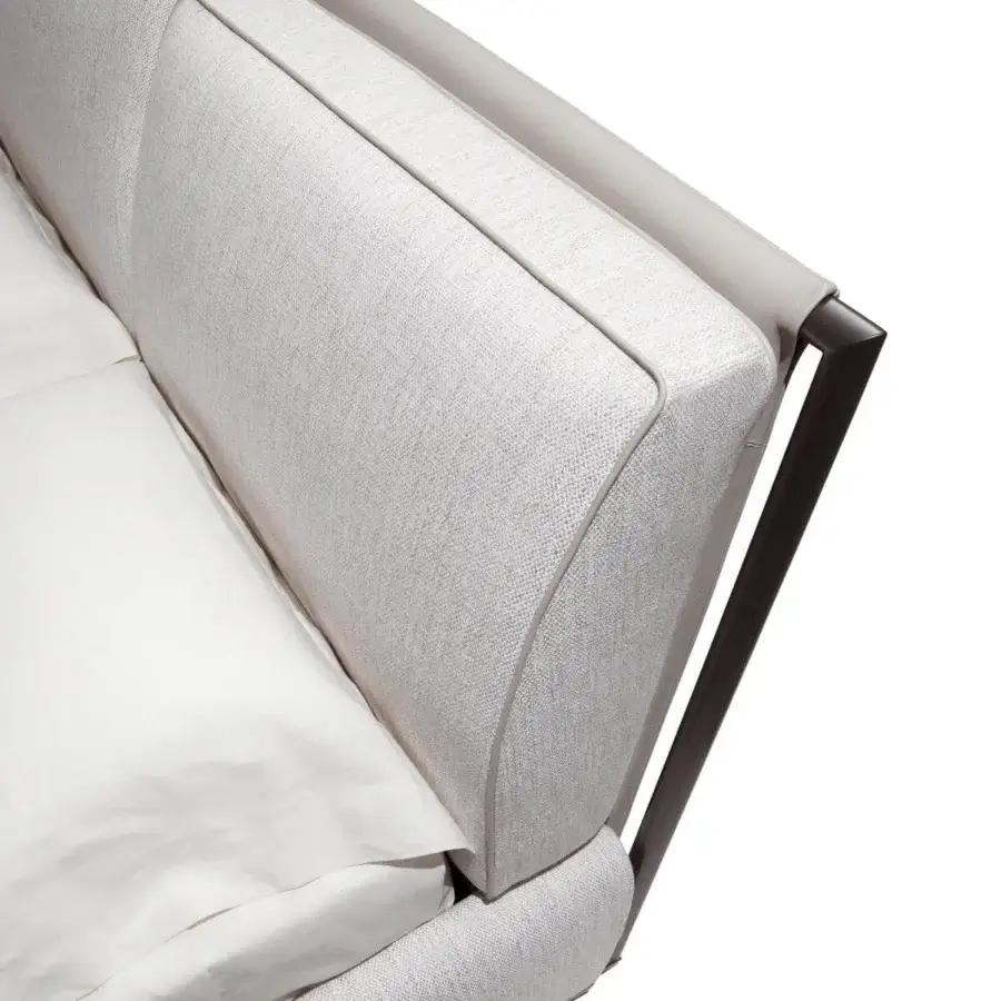 Distinguished Giorgetti Adam bed with curved headboard upholstered in light textile and framed in saddle leather with metal support